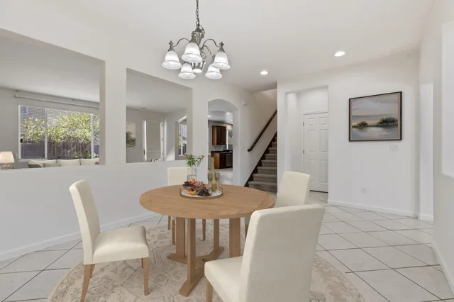 a view of a dining room with furniture and chandelier