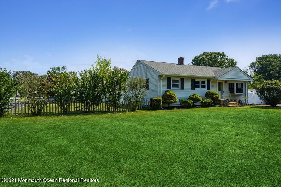 665 Aldrich Road Howell, NJ 07731 - Photo 22 of 23 a front view of a house with a yard table and chairs