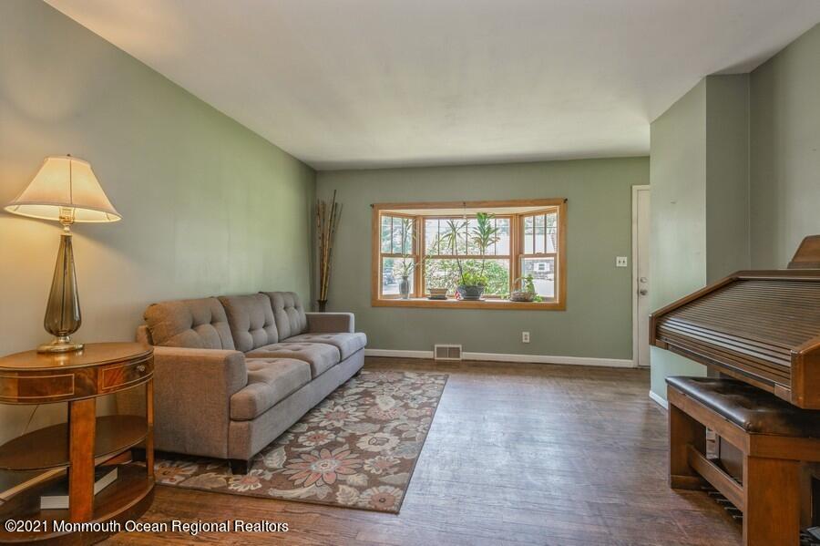 665 Aldrich Road Howell, NJ 07731 - Photo 5 of 23 a living room with a couch and a stove top oven
