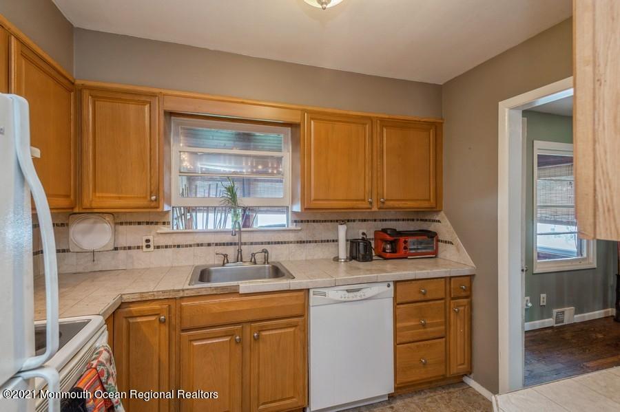 665 Aldrich Road Howell, NJ 07731 - Photo 8 of 23 a kitchen with a sink stove and cabinets