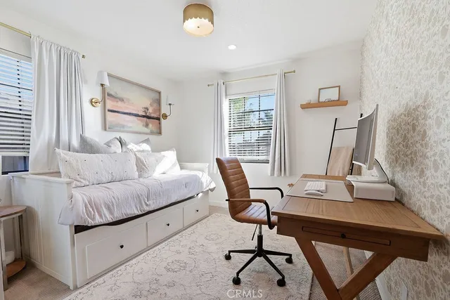 a bedroom with a bed couch and a window