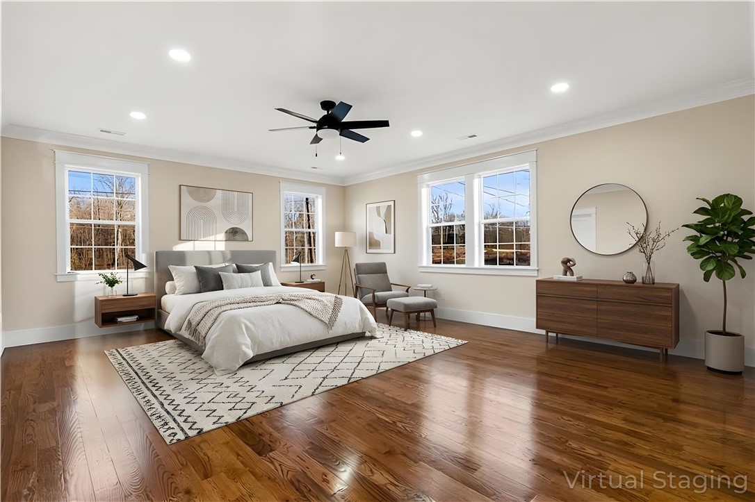 303 Regency Circle Anderson, SC 29625 - Photo 13 of 50 This upscale bedroom features elegant hardwood floors and ample natural light from multiple windows.