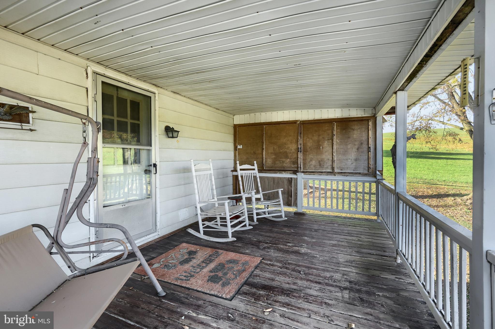 2121 Stauffer Road Seven Valleys, PA 17360 - Photo 5 of 47 a view of a porch with wooden floor chairs and yard