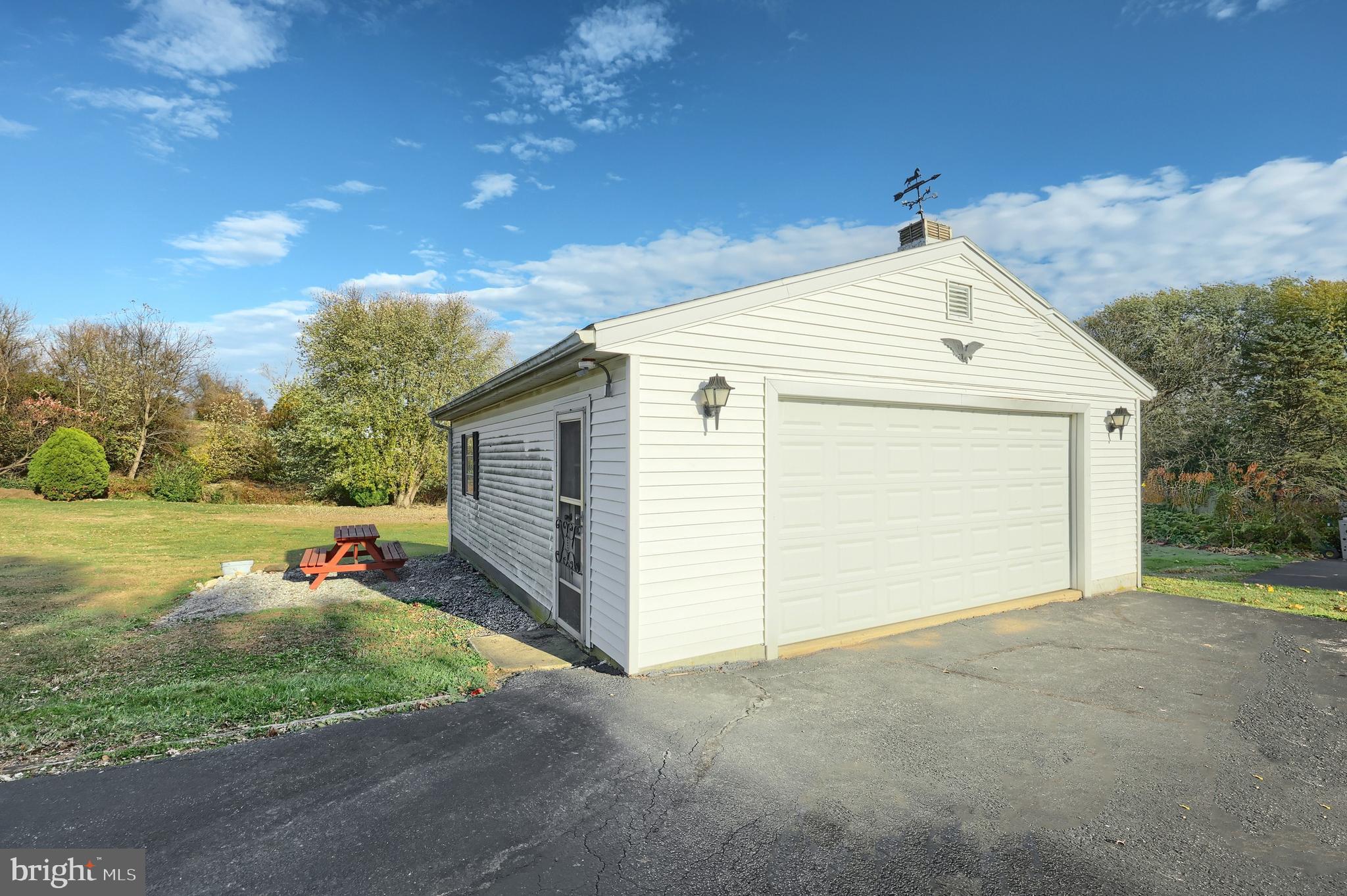 2121 Stauffer Road Seven Valleys, PA 17360 - Photo 9 of 47 a view of a white house with a yard and garage