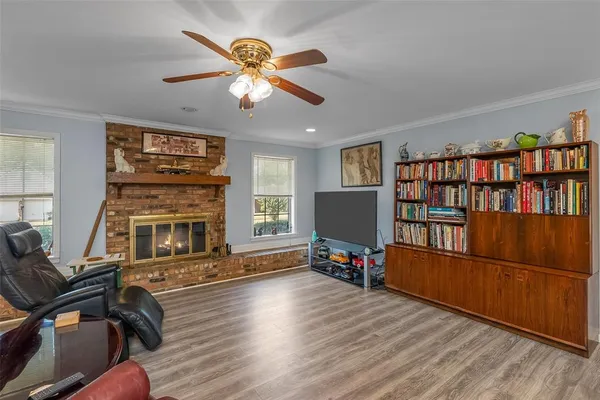 a living room with fireplace furniture and a flat screen tv