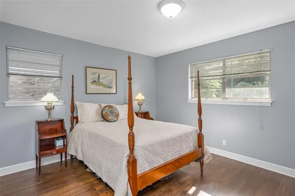 a bedroom with a bed a table and a window