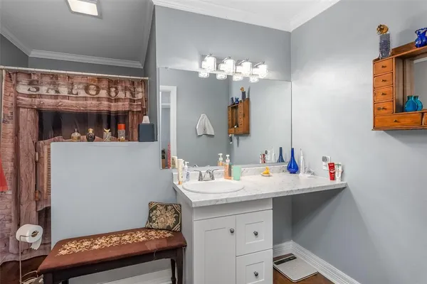 a bathroom with a sink mirror and vanity
