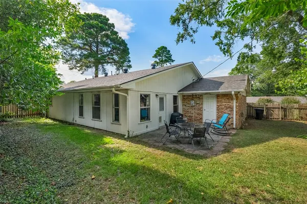 a view of a house with backyard sitting area and garden