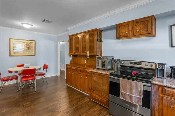 a kitchen with stainless steel appliances kitchen island granite countertop a stove top oven