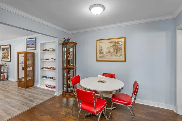 a dining room with furniture and wooden floor