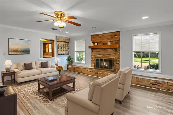 a living room with furniture a chandelier and a fireplace