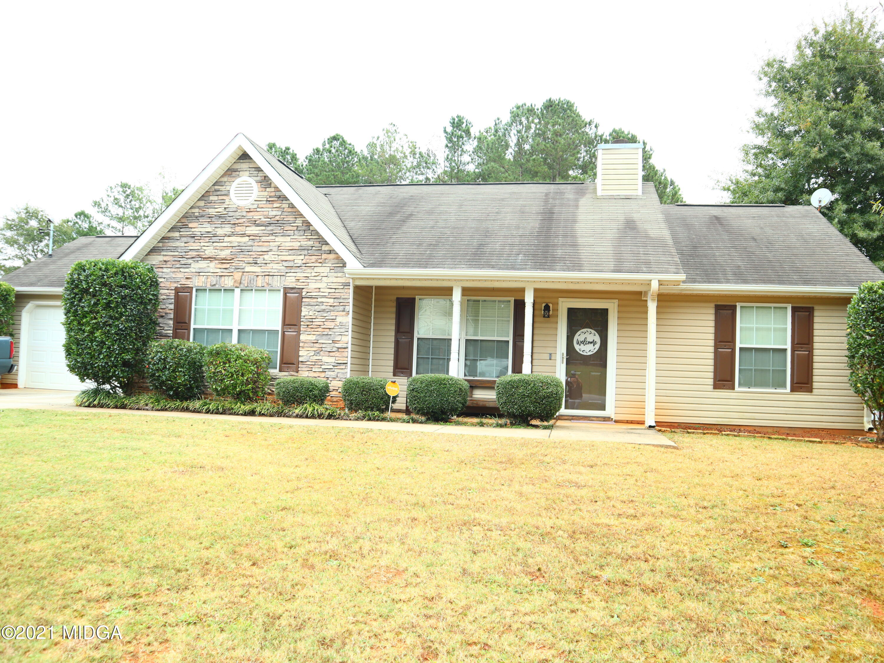 a front view of house with yard and green space