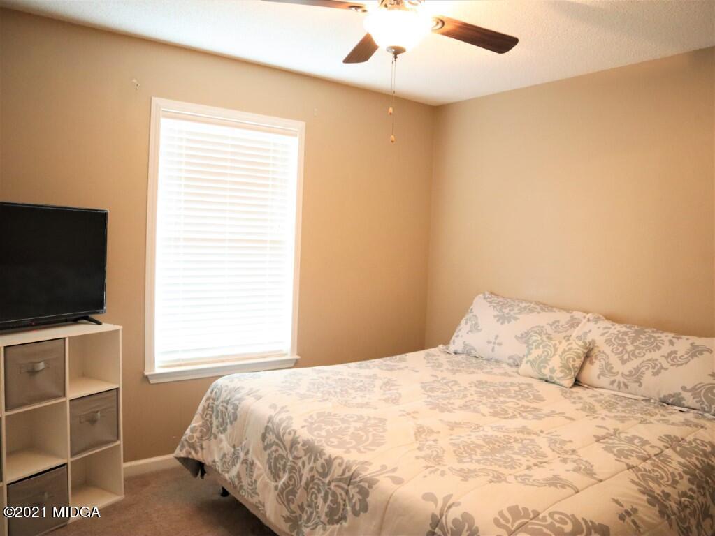 204 Autumn Ridge Court Gray, GA 31032 - Photo 14 of 20 a bedroom with a bed and a flat screen tv