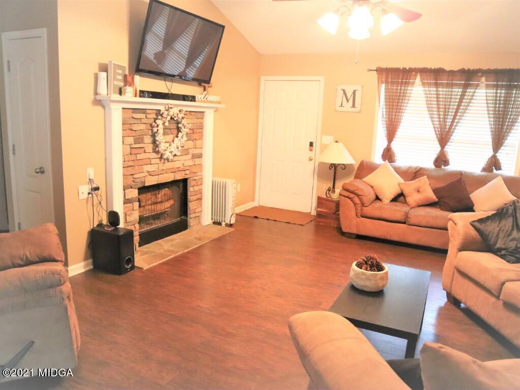 204 Autumn Ridge Court Gray, GA 31032 - Photo 3 of 20 a living room with furniture and a fireplace