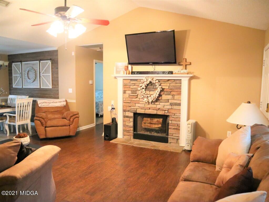 204 Autumn Ridge Court Gray, GA 31032 - Photo 4 of 20 a living room with furniture a flat screen tv and a fireplace