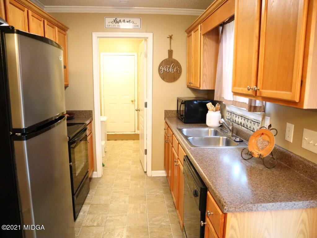 204 Autumn Ridge Court Gray, GA 31032 - Photo 6 of 20 a kitchen with sink refrigerator and window