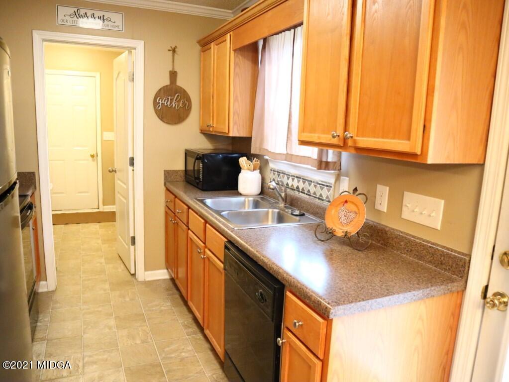 204 Autumn Ridge Court Gray, GA 31032 - Photo 7 of 20 a kitchen with stainless steel appliances a sink a stove and a refrigerator