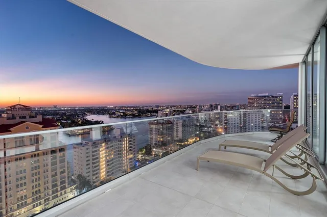 a living room with furniture kitchen view and a large window