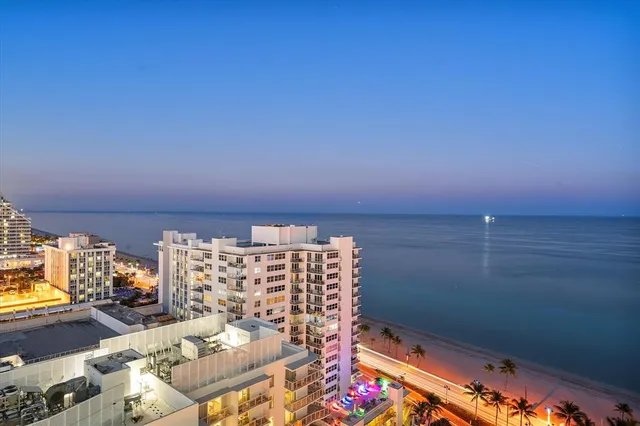 a living room with furniture a chandelier and a large window