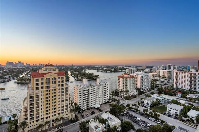 a kitchen with stainless steel appliances kitchen island a white stove top oven and sink