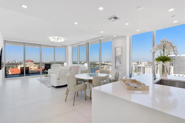 a kitchen with kitchen island granite countertop a sink cabinets and wooden floor