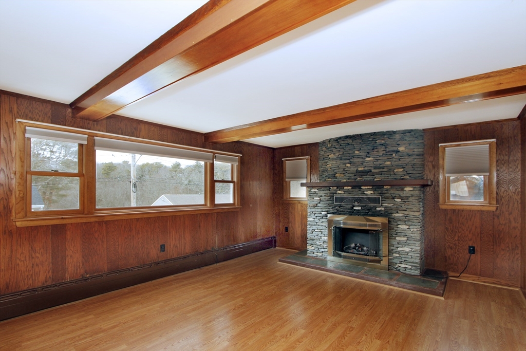4 Van Bummel Road Bourne, MA 02532 - Photo 12 of 25 a view of empty room with fireplace and wooden floor
