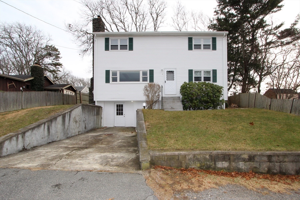 4 Van Bummel Road Bourne, MA 02532 - Photo 2 of 25 a front view of a house with a yard