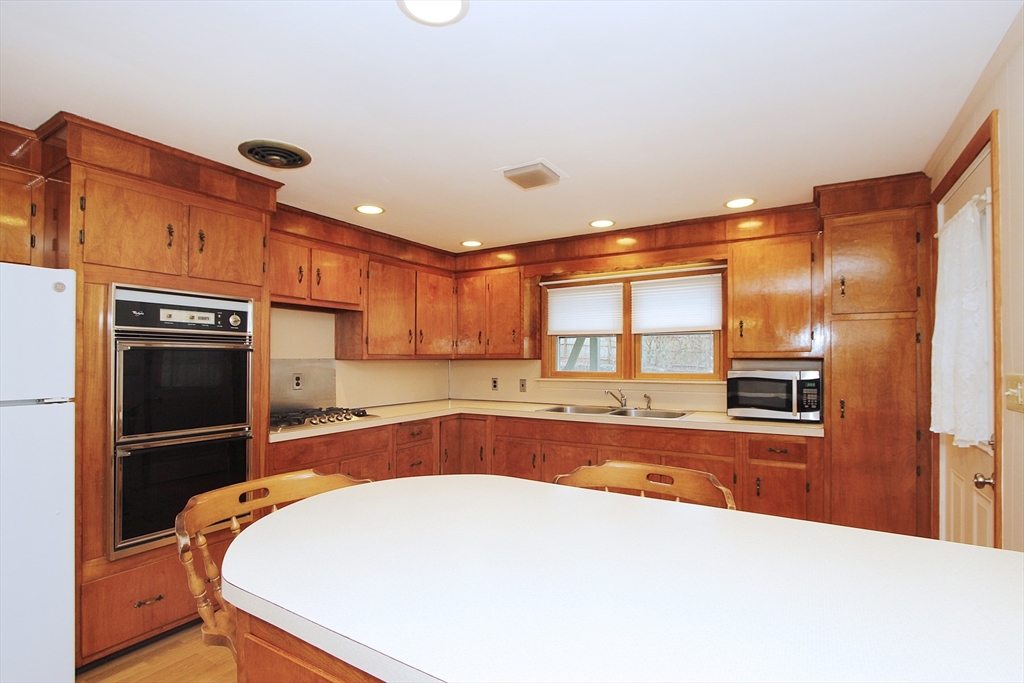 4 Van Bummel Road Bourne, MA 02532 - Photo 6 of 25 a kitchen with stainless steel appliances a stove and a refrigerator