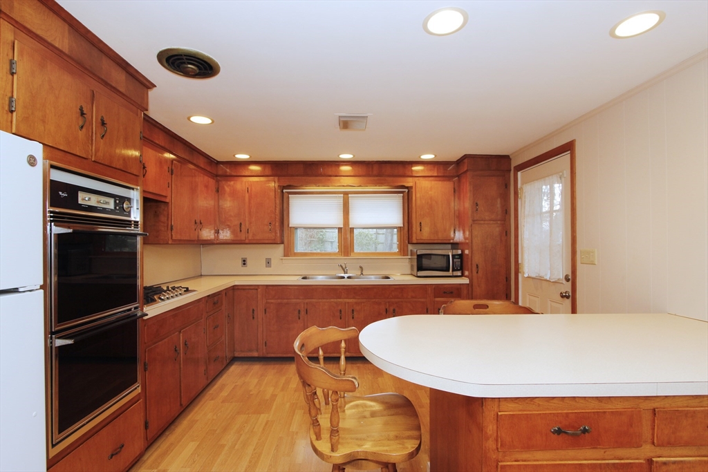 4 Van Bummel Road Bourne, MA 02532 - Photo 7 of 25 a large kitchen with stainless steel appliances a large counter top