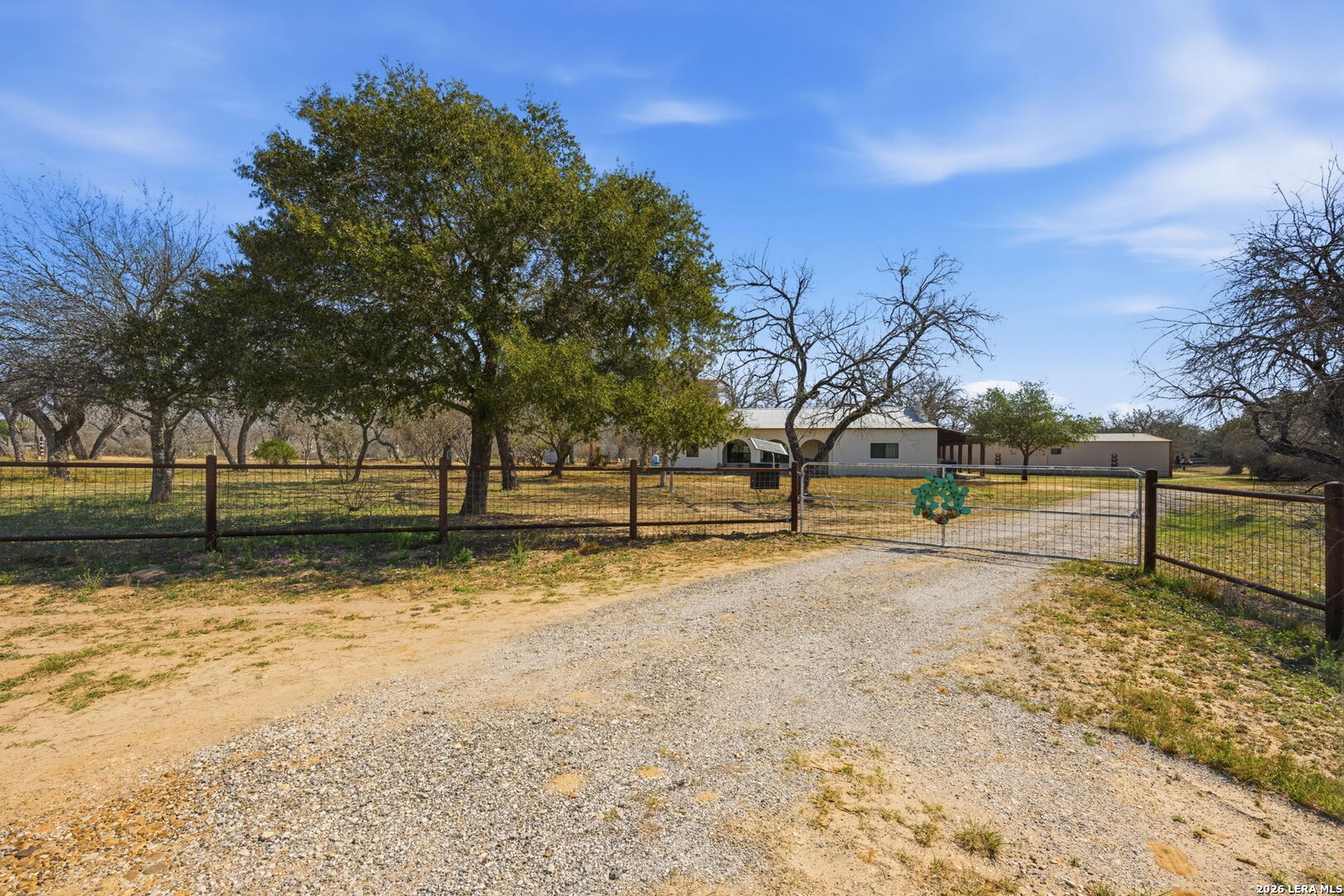 1150 Bruce Road Poteet, TX 78065 - Photo 1 of 33 a view of dirt yard with large trees