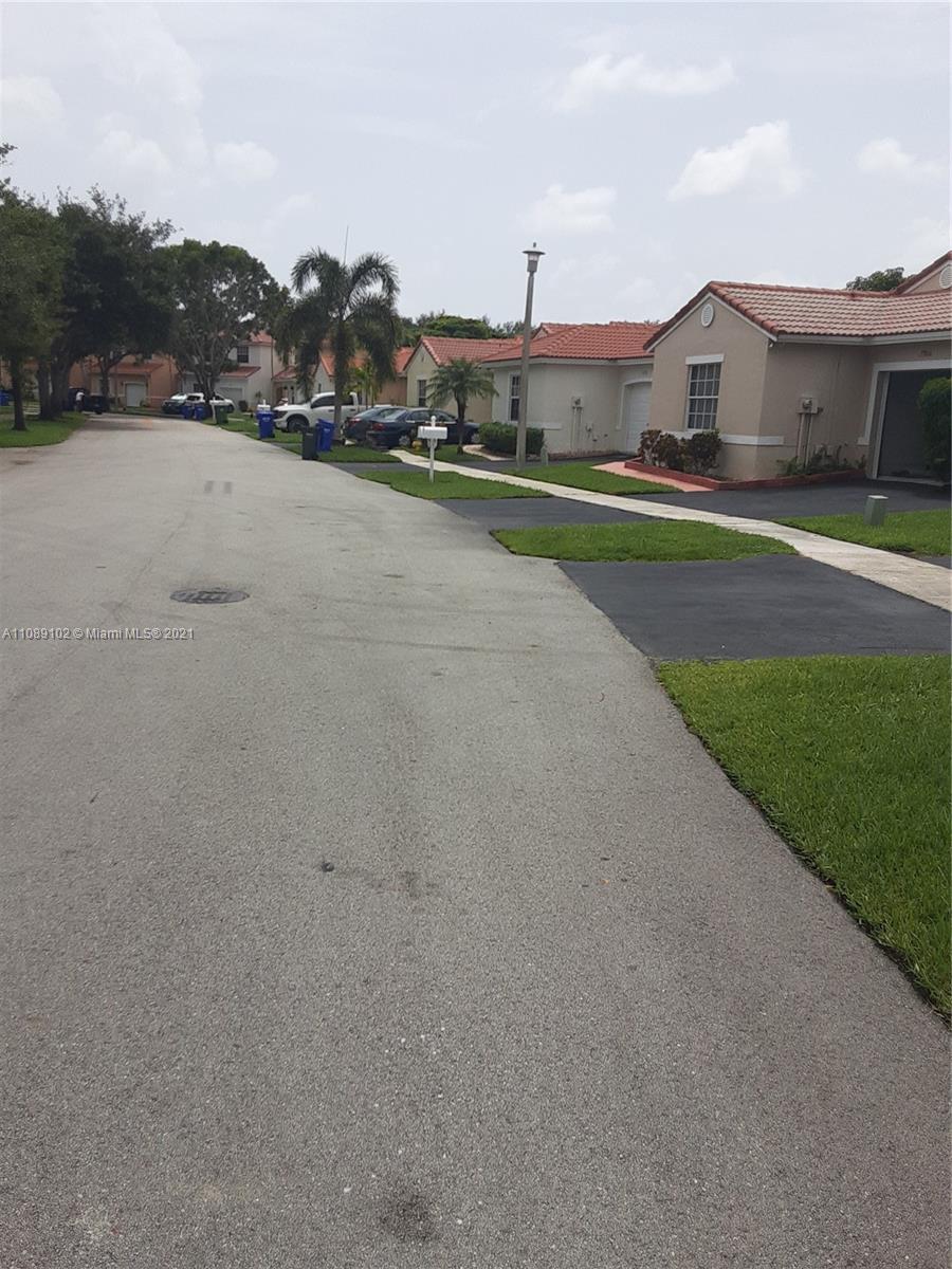 Silver Lakes Pembroke Pines, FL 33029 - Photo 2 of 19 a view of big house with a big yard and large trees