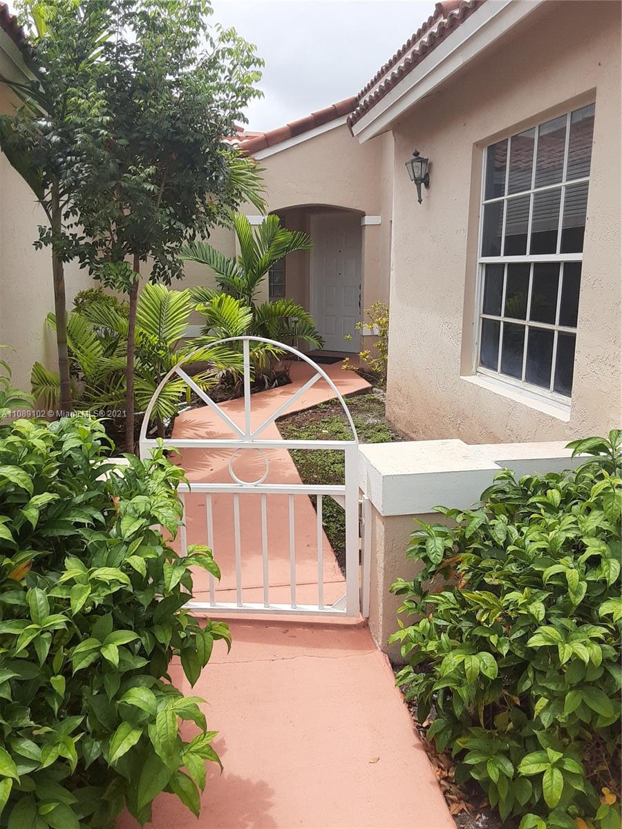 Silver Lakes Pembroke Pines, FL 33029 - Photo 7 of 19 a front view of a house with a yard and garage