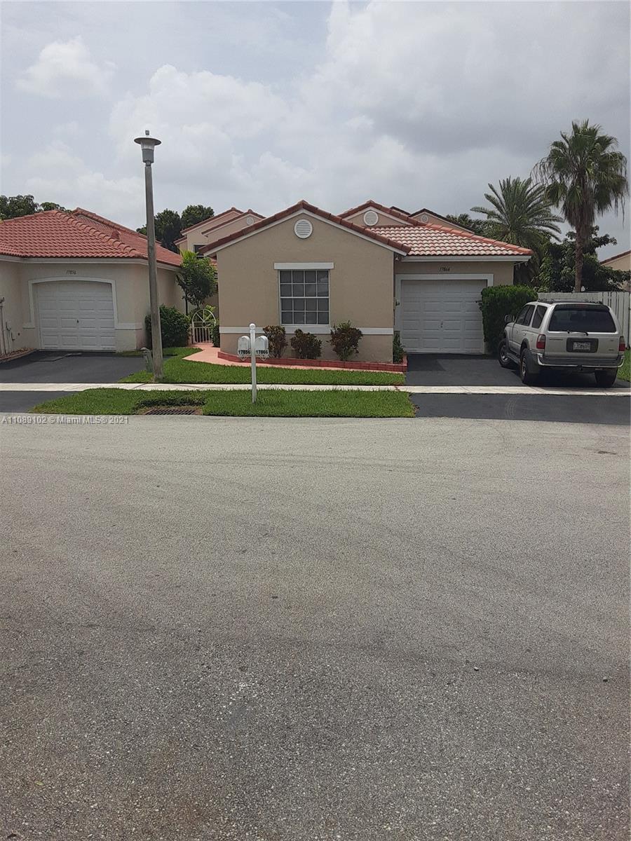 Silver Lakes Pembroke Pines, FL 33029 - Photo 8 of 19 a front view of a house with a yard and garage