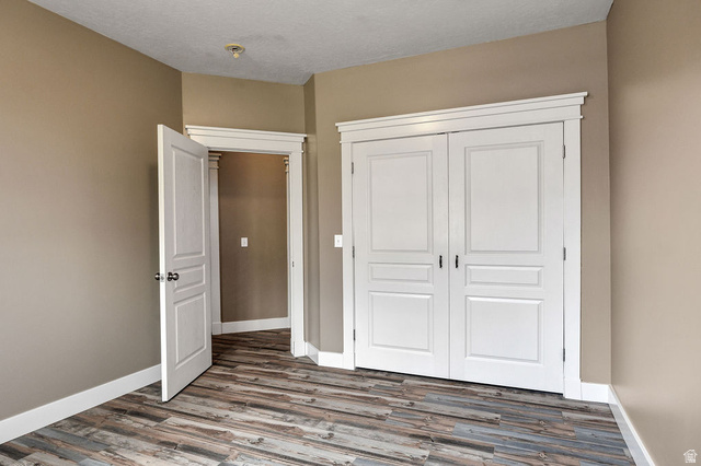 288 525 South Providence, UT 84332 - Photo 23 of 71 Room featuring wood-finish flooring, neutral wall paint, and white trim