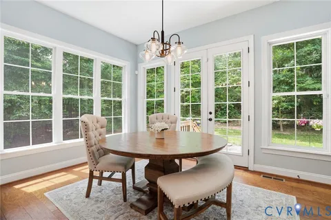 a view of a dining room with furniture wooden floor and a chandelier