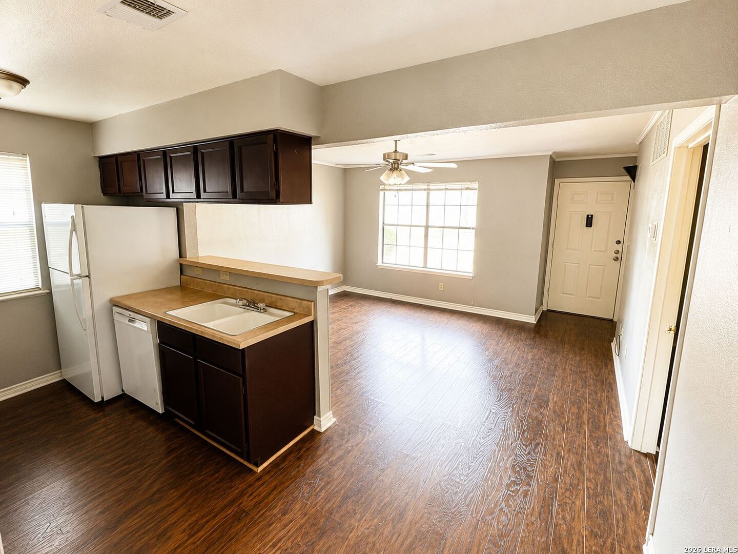 11610 Vance Jackson Road, Unit 867 San Antonio, TX 78230 - Photo 6 of 10 a view of kitchen with stainless steel appliances a refrigerator and wooden floor