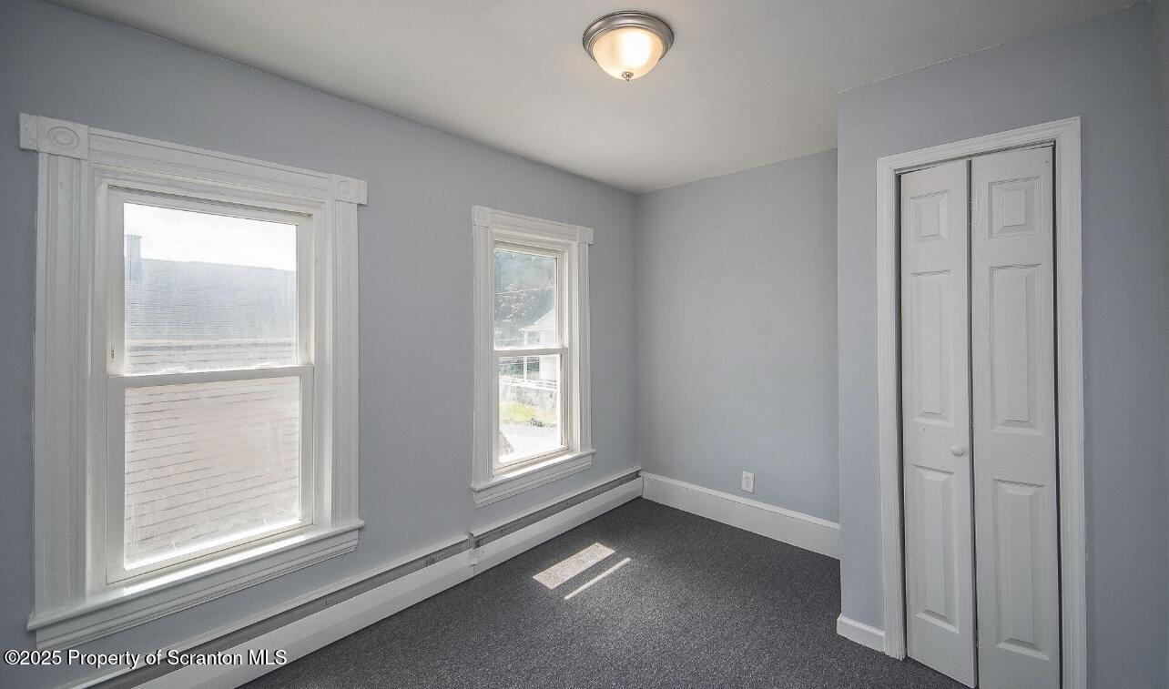 144 Jefferson Street Simpson, PA 18407 - Photo 11 of 14 an empty room with windows and closet