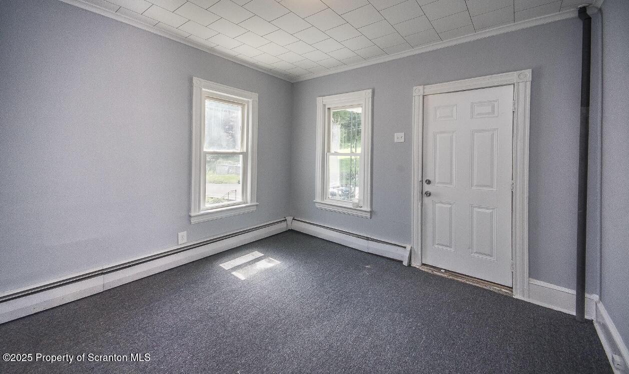 144 Jefferson Street Simpson, PA 18407 - Photo 4 of 14 an empty room with windows