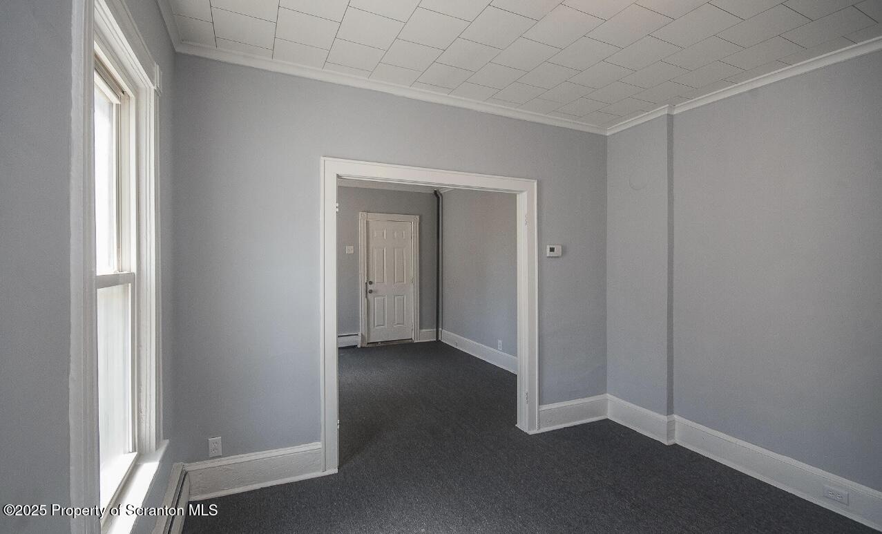 144 Jefferson Street Simpson, PA 18407 - Photo 5 of 14 an empty room with windows