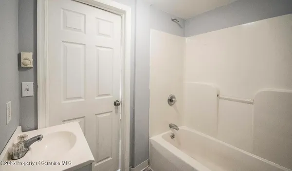 a bathroom with a bathtub and shower