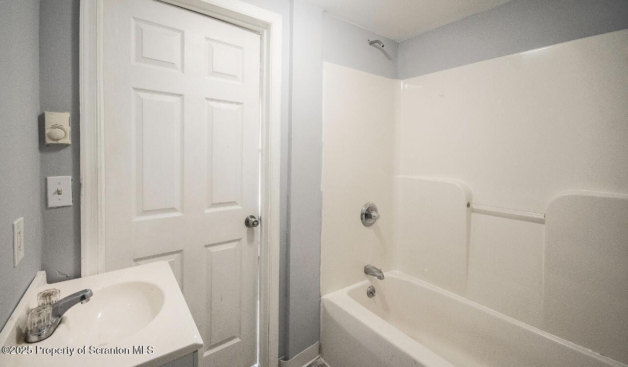 144 Jefferson Street Simpson, PA 18407 - Photo 8 of 14 a bathroom with a bathtub and shower
