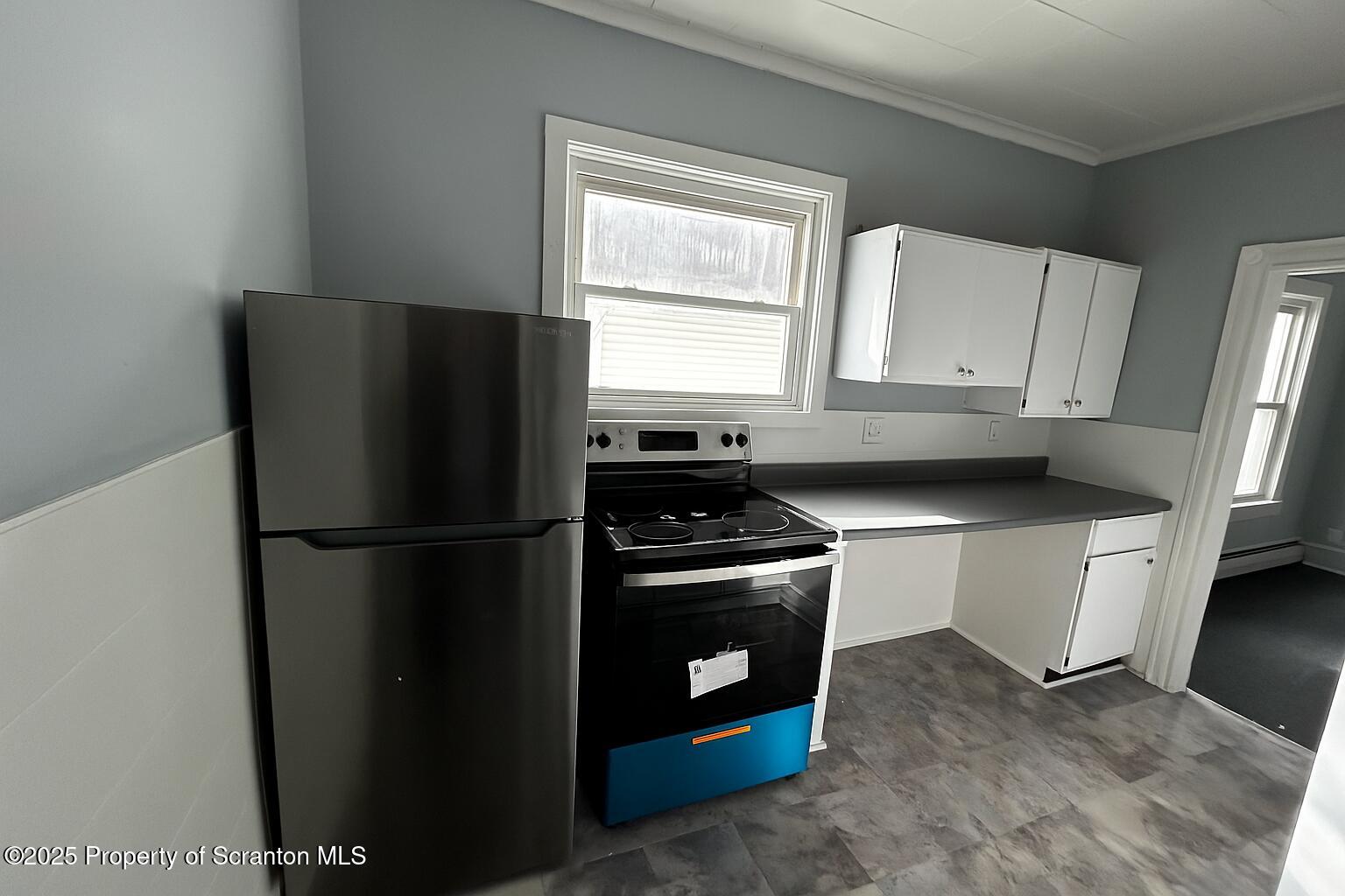 144 Jefferson Street Simpson, PA 18407 - Photo 9 of 14 a white refrigerator freezer and a stove sitting inside of a kitchen