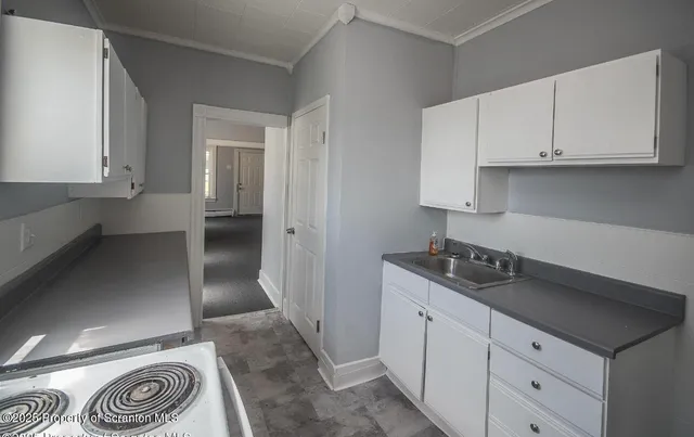 a kitchen with stainless steel appliances granite countertop a sink and a stove