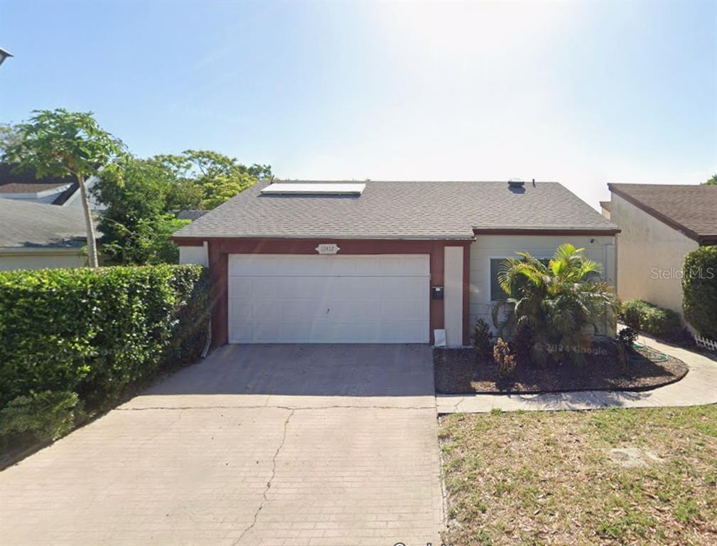 12412 Rodeo Lane Hudson, FL 34667 - Photo 1 of 1 a front view of a house with a yard