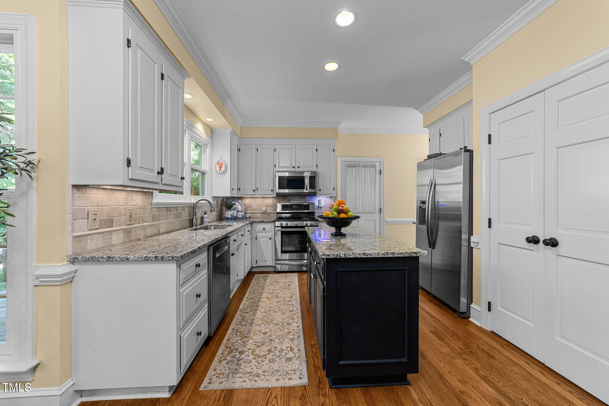 2645 Ridgewell Court Raleigh, NC 27613 - Photo 8 of 45 a kitchen with granite countertop stainless steel appliances and wooden cabinets