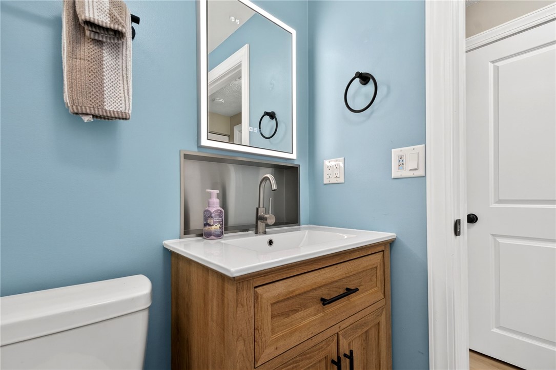 5975 Rosalie Road Dayton, OH 45424 - Photo 16 of 48 This clean and inviting bathroom features a modern vanity and a bright mirror.