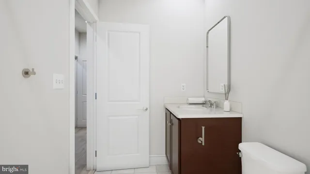 a bathroom with a sink toilet and vanity
