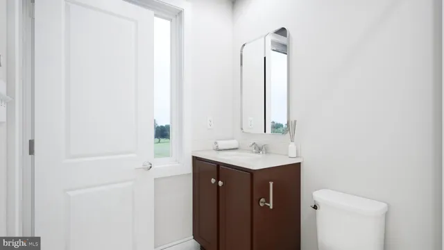 a bathroom with a toilet a sink and mirror
