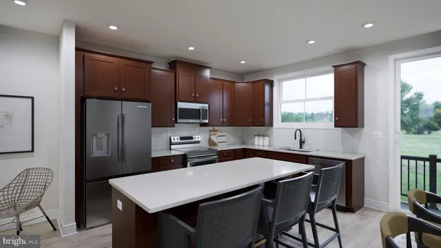 a kitchen with a table chairs refrigerator and microwave