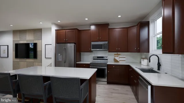 a kitchen with stainless steel appliances kitchen island granite countertop a sink a stove a refrigerator cabinets a dining table and chairs